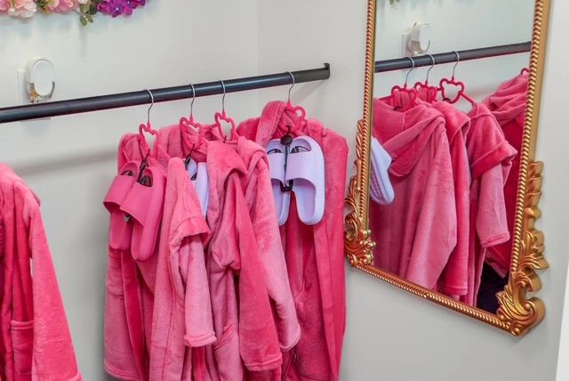 Pink towels and robes on display rack