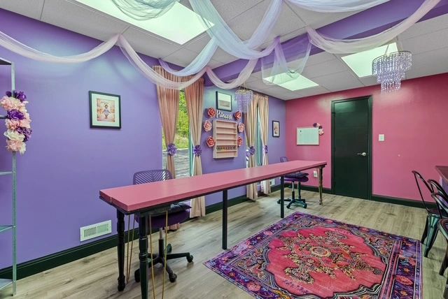 Creative studio event room with purple and pink walls