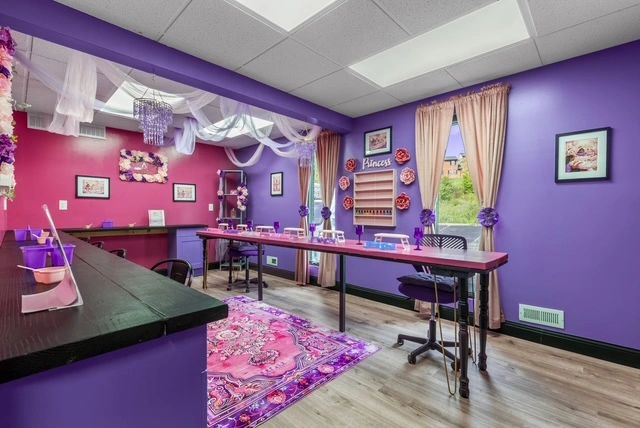 Spa venue craft room with purple and hot pink walls